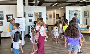 Families tour an art gallery to learn how to be in different spaces. 