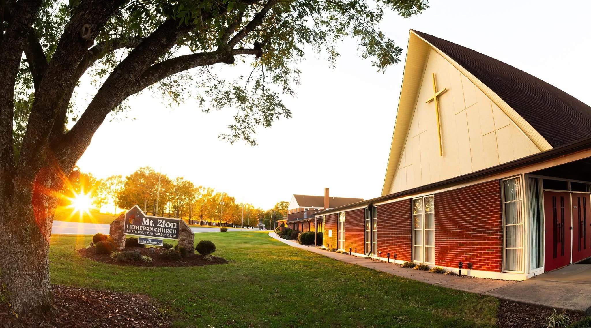The sun is shining on the front of Mt. Zion Lutheran Church.
