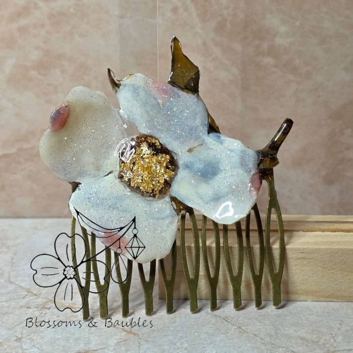 Dogwood blossom on bronze comb