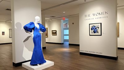 Blue formal gown designed by Charles Harbison along side the painting of a woman in a blue dress